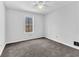 Bright bedroom with grey carpet, ceiling fan and window at 4435 Coopers Creek Se Dr, Smyrna, GA 30082