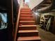 Staircase leading down to a basement, surrounded by utilities and storage areas at 8587 Cumming Hwy, Canton, GA 30115