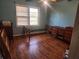 A bedroom with hardwood floors, blue walls, and lots of space at 8587 Cumming Hwy, Canton, GA 30115