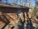 Single-story brick house exterior with an entrance door and a concrete driveway at 8587 Cumming Hwy, Canton, GA 30115