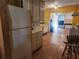 Spacious kitchen features a refrigerator, cabinets, and a view of the stove area, ready for renovation at 8587 Cumming Hwy, Canton, GA 30115