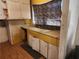 Vintage kitchen features yellow countertops, double sink, and cabinets with visible wear at 8587 Cumming Hwy, Canton, GA 30115