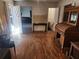 A spacious living room with hardwood floors offers lots of sunlight, and shows access to other rooms at 8587 Cumming Hwy, Canton, GA 30115