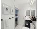 Modern bathroom with framed art on the wall, a large mirror, toilet, and sink with black fixtures at 220 Renaissance Pkwy # 1203, Atlanta, GA 30308