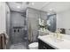 Modern bathroom featuring a glass-enclosed shower, sleek vanity, and stylish grey tile at 220 Renaissance Pkwy # 1203, Atlanta, GA 30308