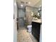 Modern bathroom featuring a glass-enclosed shower, sleek vanity, and stylish grey tile at 220 Renaissance Pkwy # 1203, Atlanta, GA 30308