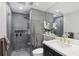 Modern bathroom featuring gray tile, glass shower, sleek vanity, and elegant fixtures at 220 Renaissance Pkwy # 1203, Atlanta, GA 30308