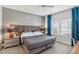 Comfortable bedroom features large windows with bright natural light, gray bedding, and a ceiling fan at 220 Renaissance Pkwy # 1203, Atlanta, GA 30308