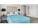 Cozy bedroom with blue bedding, bedside lamps, and french doors leading to another room at 220 Renaissance Pkwy # 1203, Atlanta, GA 30308