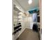 Walk-in closet with metal shelving provides ample storage space for shoes and clothing at 220 Renaissance Pkwy # 1203, Atlanta, GA 30308