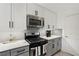Modern kitchen with stainless steel appliances, quartz countertops, and white subway tile backsplash at 220 Renaissance Pkwy # 1203, Atlanta, GA 30308