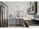 Modern kitchen featuring stainless steel appliances, gray cabinets, and an open layout at 220 Renaissance Pkwy # 1203, Atlanta, GA 30308