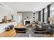 Bright living room with hardwood floors, fireplace, and large windows with draperies at 220 Renaissance Pkwy # 1203, Atlanta, GA 30308
