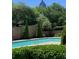 Beautiful community pool surrounded by greenery and mature landscaping at 220 Renaissance Pkwy # 1203, Atlanta, GA 30308