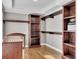 Walk-in closet features wood floors and custom built-in shelving at 3641 Carriage Glen Way, Dacula, GA 30019