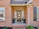 Inviting front entrance with a decorative wreath and potted plants on either side at 3641 Carriage Glen Way, Dacula, GA 30019