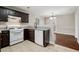 Kitchen with dark cabinets, granite counters, and white appliances at 191 Misty Ridge Trl, Stockbridge, GA 30281