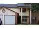 Two-story house with a two-car garage and a well-maintained lawn at 1969 Corners Cir, Lithonia, GA 30058
