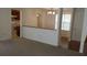 Living room with hardwood and carpeted floors, and a view into the kitchen at 1969 Corners Cir, Lithonia, GA 30058