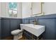 Powder room with pedestal sink and blue wall at 2438 Shadburn Ferry Dr, Buford, GA 30518