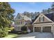 Two-story house with a three car garage and well-manicured lawn at 380 S Woodland Sw Dr, Marietta, GA 30064