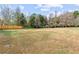 Spacious backyard featuring a wooden fence and mature trees, perfect for outdoor activities and privacy at 5515 Hancock Ln, Cumming, GA 30041