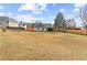 Large, grassy backyard surrounded by a wooden fence, offering ample space and privacy at 5515 Hancock Ln, Cumming, GA 30041