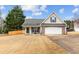 Charming home featuring stone accents, a two-car garage, and a well-maintained lawn at 5515 Hancock Ln, Cumming, GA 30041