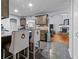 Open-concept kitchen featuring granite countertops and views of living area with fireplace at 5515 Hancock Ln, Cumming, GA 30041