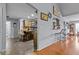 View of the kitchen bar, wood cabinets, and an open design to the living area at 5515 Hancock Ln, Cumming, GA 30041