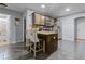 Kitchen island with seating, stainless steel appliances, and tile flooring at 5515 Hancock Ln, Cumming, GA 30041