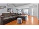 Open-concept living room featuring hardwood floors, a gray sofa, and lots of light at 5515 Hancock Ln, Cumming, GA 30041