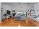 Large living room with hardwood floors, a gray sofa, and a stone fireplace at 5515 Hancock Ln, Cumming, GA 30041
