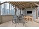 Rooftop grilling station with dining area and TV at 1080 Peachtree St # 2406, Atlanta, GA 30309