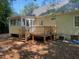 Home features a wooden deck with stairs and screened porch at 2351 Johnson Ferry Ne Rd, Chamblee, GA 30341