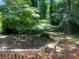 Large backyard with mature trees and stone pathway at 2351 Johnson Ferry Ne Rd, Chamblee, GA 30341