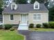 Beige house exterior with gray roof, steps, and green landscaping at 2351 Johnson Ferry Ne Rd, Chamblee, GA 30341