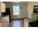 Eat-in kitchen with white cabinets, granite countertops, and hardwood floors at 2351 Johnson Ferry Ne Rd, Chamblee, GA 30341