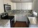 Galley-style kitchen with white cabinets, granite countertops, and stainless steel appliances at 2351 Johnson Ferry Ne Rd, Chamblee, GA 30341