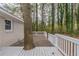 A beautiful wooden deck with white railing surrounds a mature tree, offering a unique outdoor space at 3881 Bonnie Se Ln, Atlanta, GA 30354