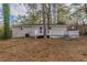 This home features a spacious backyard with a white-railed deck, ideal for outdoor entertaining and relaxation at 3881 Bonnie Se Ln, Atlanta, GA 30354