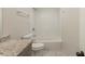 This well-lit bathroom includes a shower over the bathtub, white subway tile, and a granite-topped vanity at 3881 Bonnie Se Ln, Atlanta, GA 30354