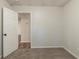 This bedroom features neutral walls, carpet, and a door opening to another room, creating a cozy and inviting space at 3881 Bonnie Se Ln, Atlanta, GA 30354