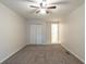 Neutral bedroom featuring a ceiling fan, closet space, and carpeted floors at 3881 Bonnie Se Ln, Atlanta, GA 30354