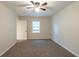 Neutral bedroom featuring a ceiling fan, closet space, and carpeted floors at 3881 Bonnie Se Ln, Atlanta, GA 30354