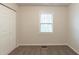 Bedroom showcasing carpeted floors, neutral paint, and a built-in closet at 3881 Bonnie Se Ln, Atlanta, GA 30354