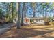 Charming single-story home featuring a bright red front door and a cozy front porch at 3881 Bonnie Se Ln, Atlanta, GA 30354