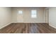 Bright living room showcasing new laminate flooring, fresh paint, and ample natural light at 3881 Bonnie Se Ln, Atlanta, GA 30354