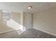 Finished basement area featuring cozy carpeting, a window, and a door for easy access at 2919 Alameda Trl, Decatur, GA 30034