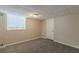 Finished basement featuring neutral walls, carpeted flooring, and a window for natural light at 2919 Alameda Trl, Decatur, GA 30034